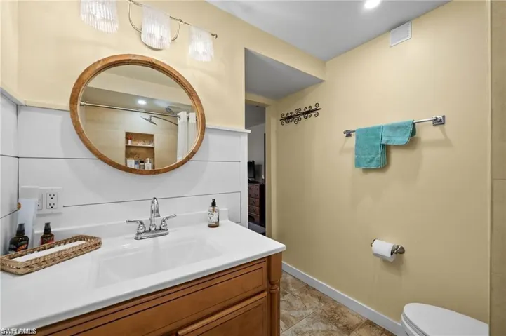Full bathroom with vanity and curtained shower