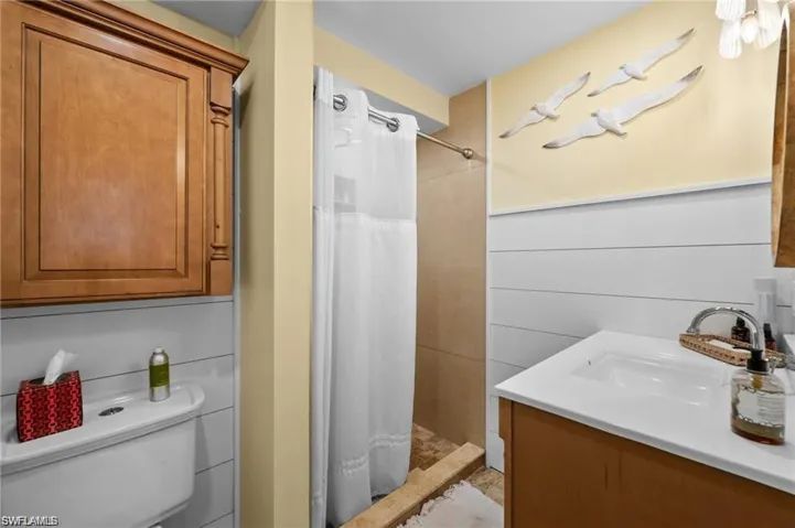 Bathroom featuring a stall shower and vanity