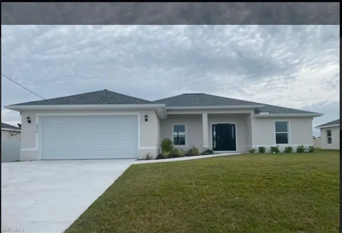 View of front facade with stucco siding, concrete driveway, an attached garage, a front yard, and covered porch