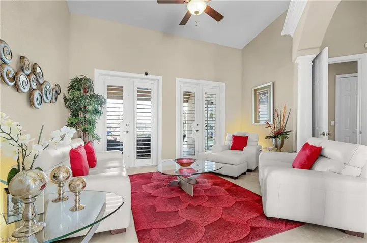 Formal Living Area w/dual glass french doors lead out to the pool