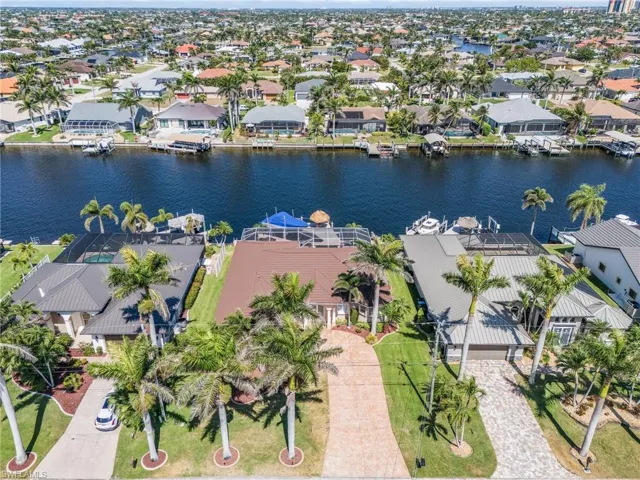 Royal palms and cluster palms adorn the front lawn landscaping. Stamped concrete driveway. 2022 asphalt coated metal roof valued @ $87,000!