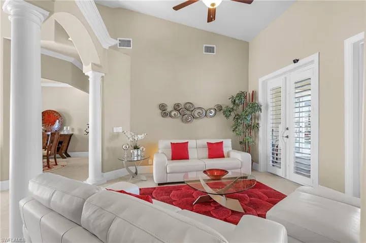 Formal Living Area w/dual glass french doors lead out to the pool