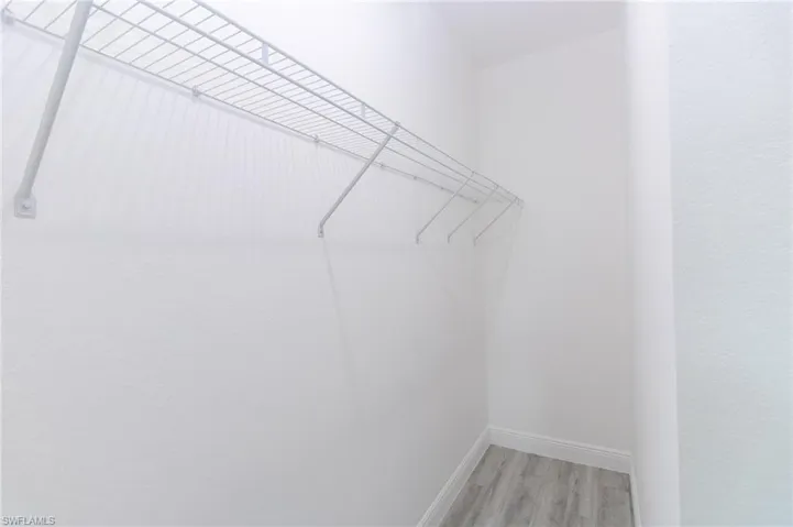 Walk in closet featuring vinyl flooring