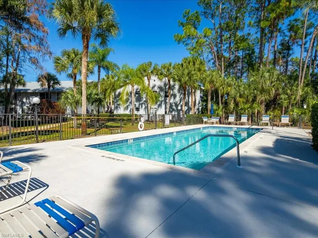 Community pool with a patio