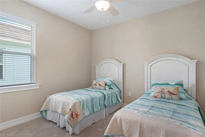 Carpeted bedroom with ceiling fan