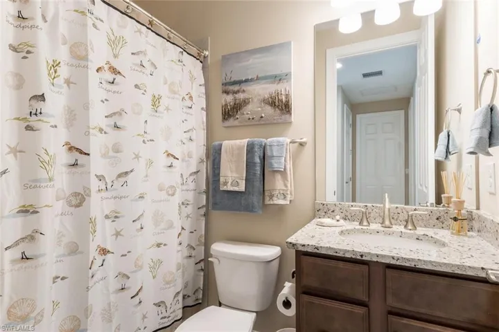 Bathroom featuring oversized vanity and toilet