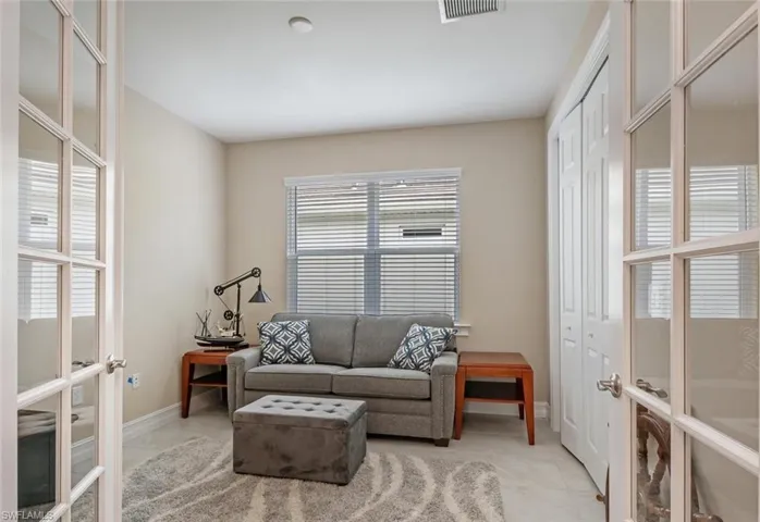 Sitting room with plenty of natural light and light tile floors