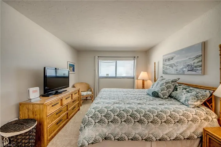 Carpeted room featuring light-colored walls and a window with horizontal blinds