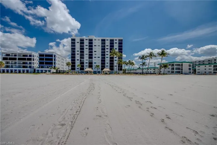 Expansive sandy beach frontage with multiple condominium buildings