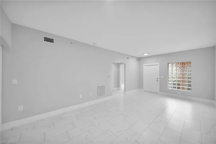 Unfurnished room featuring light tile patterned floors