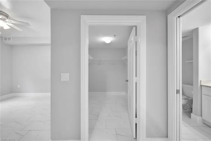 Hallway with light tile patterned floors