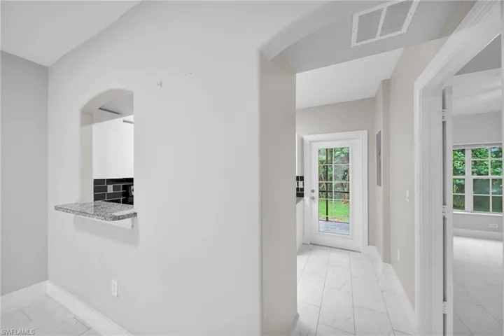 Kitchen featuring light tile patterned flooring and backsplash