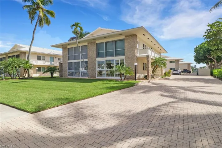 View of building exterior with decorative driveway