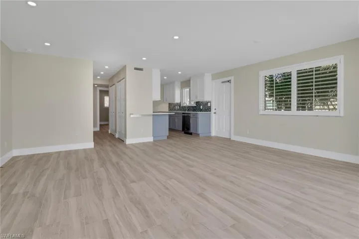 Unfurnished living room with light wood finished floors and recessed lighting