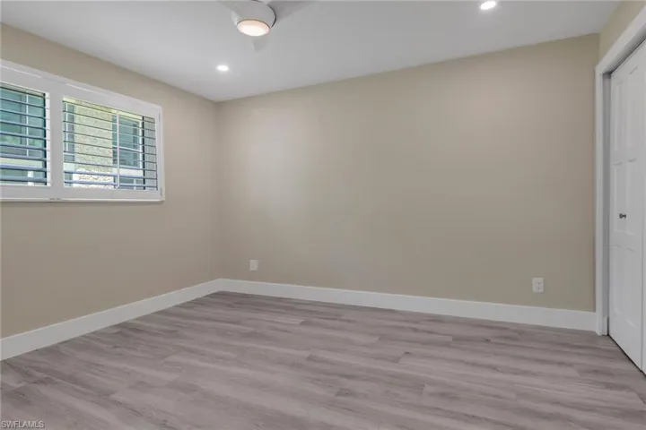 Unfurnished bedroom with a closet, light wood-style floors, a ceiling fan, and recessed lighting