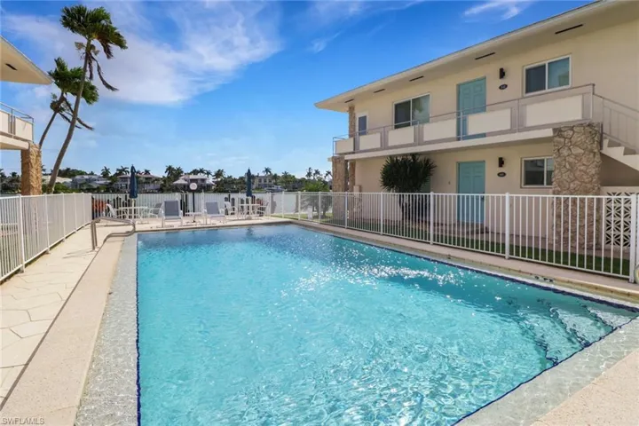 Community pool featuring a balcony and a patio