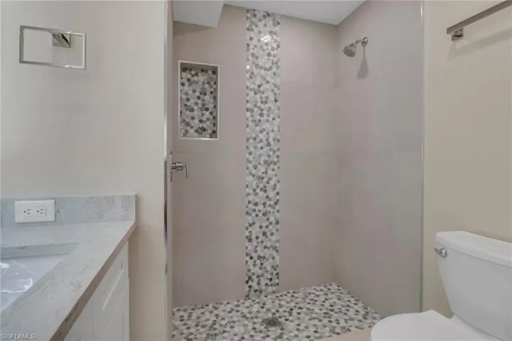 Bathroom featuring vanity and a tile shower