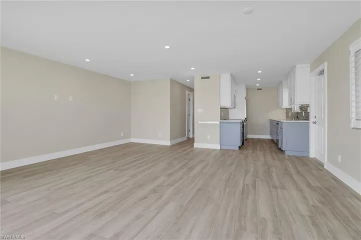 Unfurnished living room with recessed lighting and light wood-type flooring