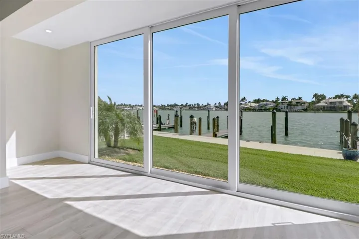 Doorway to outside featuring a water view and wood finished floors