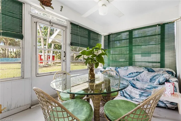 Sunroom / solarium with ceiling fan and a healthy amount of sunlight