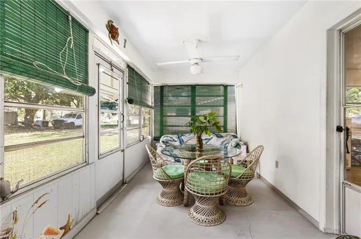 Sunroom / solarium featuring ceiling fan