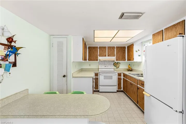 Kitchen featuring sink and white appliances