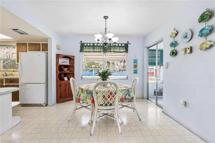 Dining area featuring sink, an inviting chandelier, and a wealth of natural light