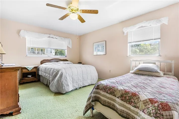 Bedroom featuring multiple windows and ceiling fan