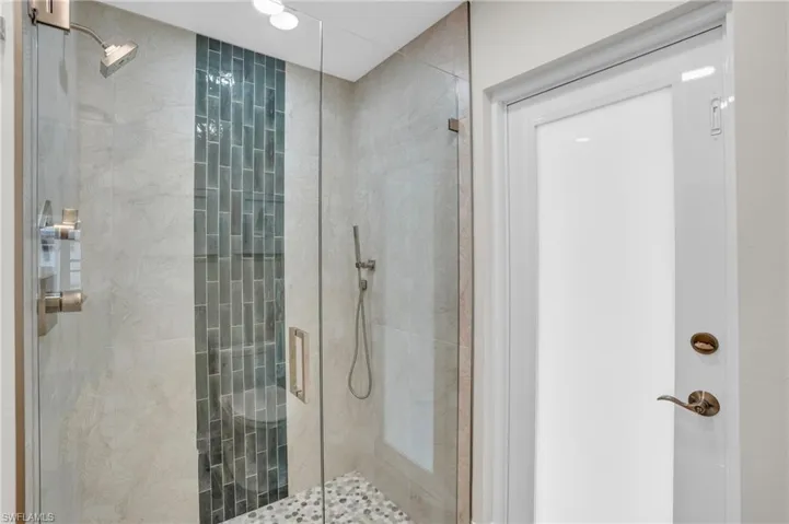 Guest Suite Bathroom Shower with door to the Lanai.  Again, the designer appointments really stand out.