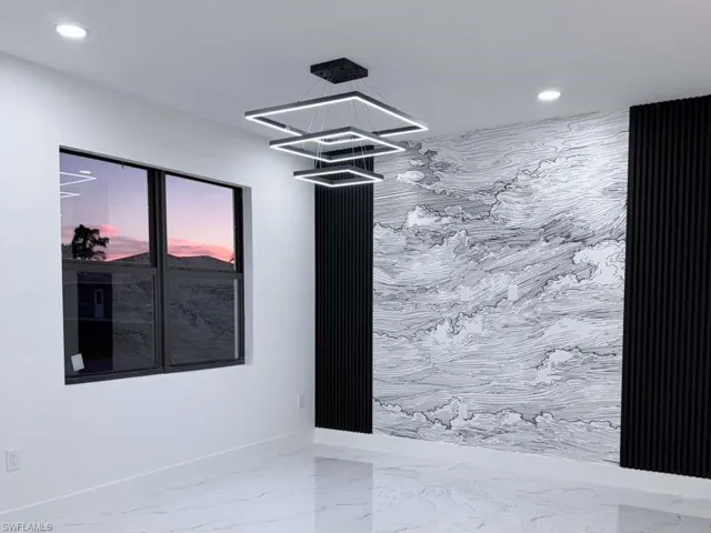 Spare room with marble finish floors, recessed lighting, and a chandelier