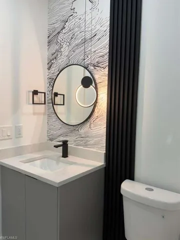 Bathroom featuring vanity and toilet