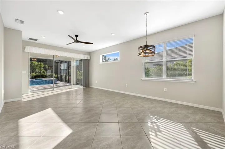 Unfurnished living room featuring a ceiling fan, visible vents, baseboards, and light tile patterned flooring