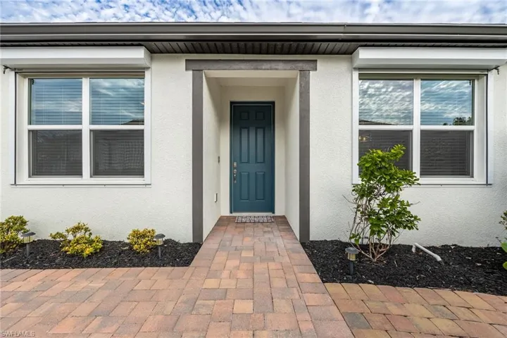 Doorway to property with stucco siding