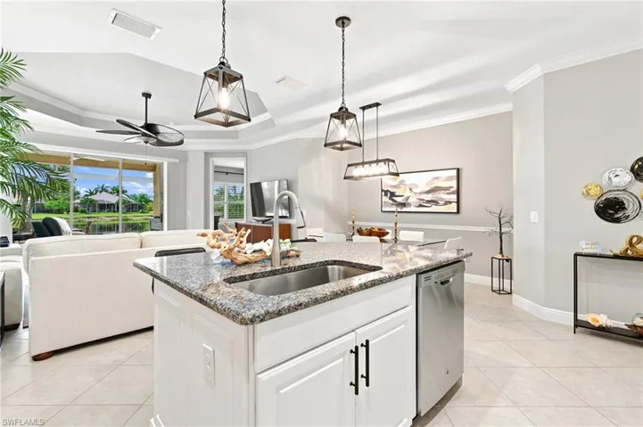 Kitchen island with a stainless steel sink and granite countertop