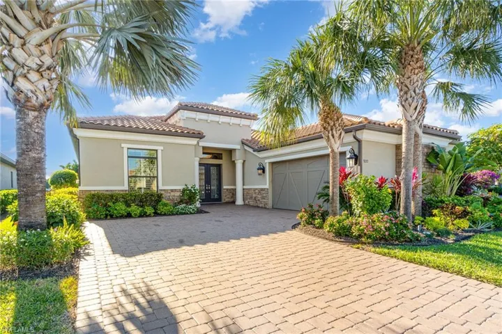 Mediterranean / spanish-style home with a garage