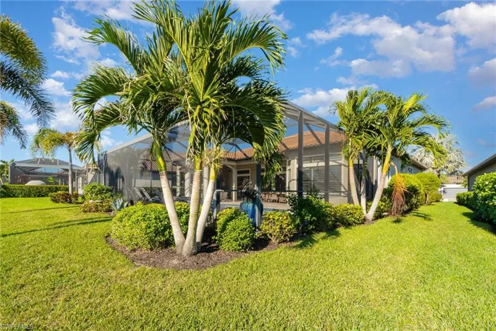 View of yard featuring glass enclosure and a swimming pool