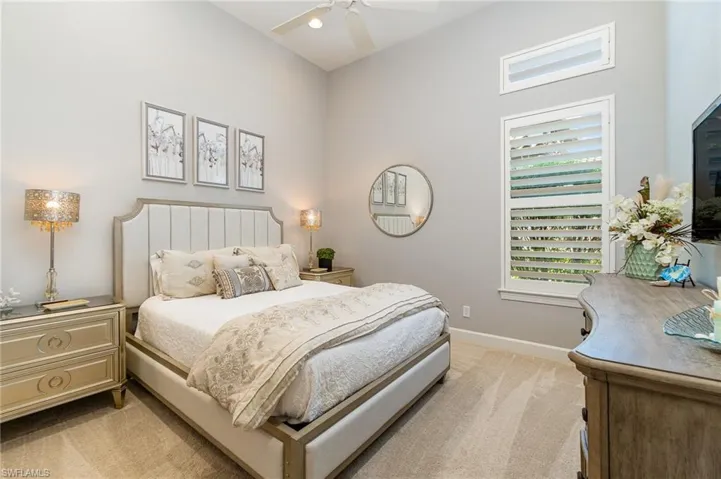 Bedroom featuring light colored carpet and ceiling fan