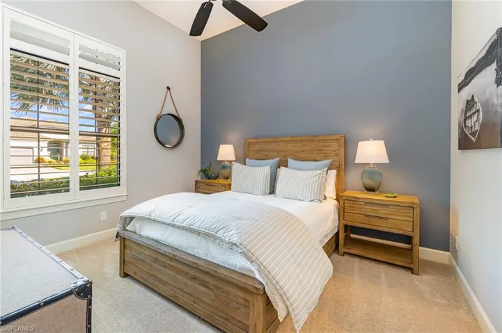 Carpeted bedroom with ceiling fan