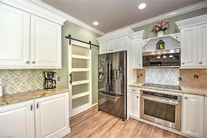 Custom Kitchen with Glass Sliding Door to Large Walk-in Pantry