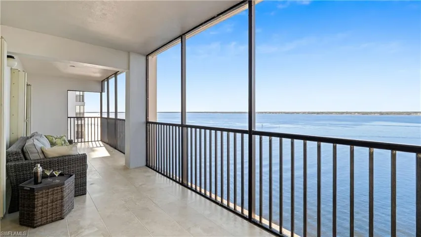 Sunroom with a water view and floor to ceiling windows