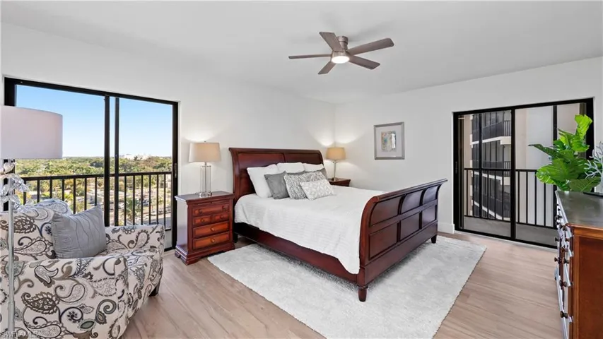 Bedroom featuring access to outside, light wood finished floors, and a ceiling fan