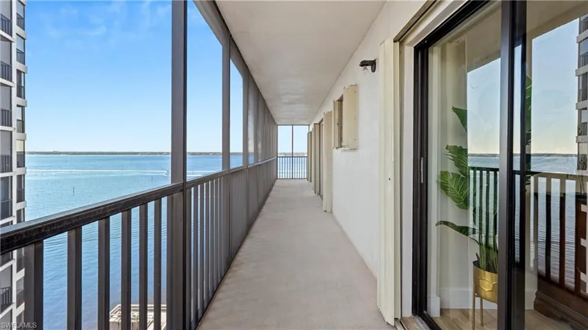 Balcony with a water view and a sunroom