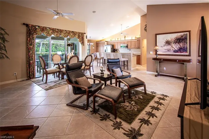 Dining area with a ceiling fan, high vaulted ceiling, light tile patterned flooring, and recessed lighting