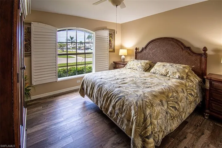 Bedroom featuring dark wood-type flooring and ceiling fan