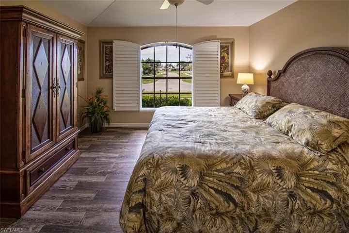 Bedroom featuring dark wood-type flooring and ceiling fan
