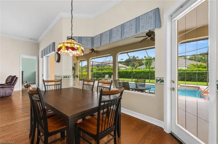 Enjoy casual dining with tranquil views from the bright breakfast nook, where large windows fill the space with natural light and overlook the screened lanai and pool beyond.