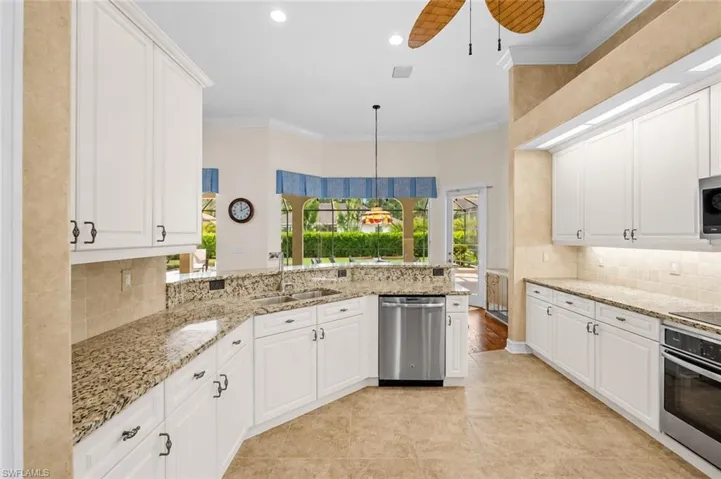 The well-appointed kitchen offers abundant cabinetry, generous counter space, newer appliances, and a functional layout.