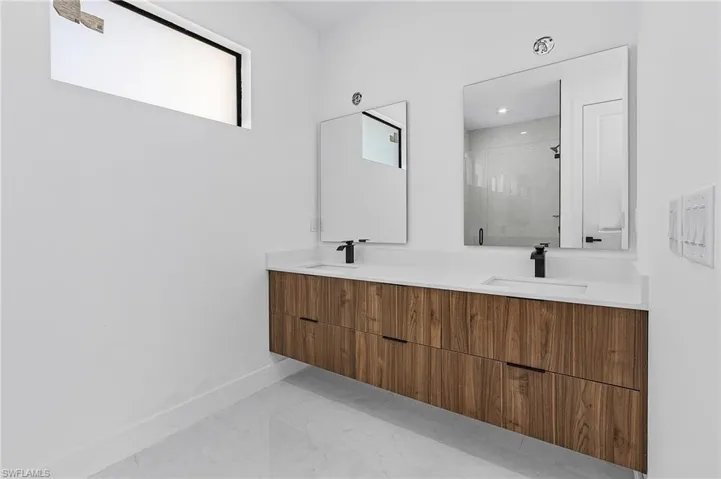 Bathroom with vanity and a shower with door