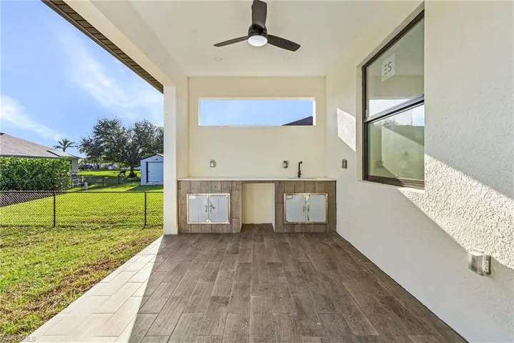 View of patio / terrace featuring ceiling fan and sink