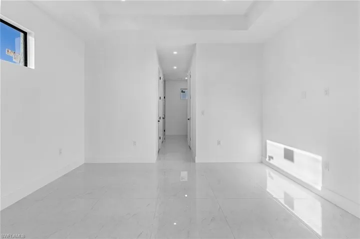 Empty room featuring a raised ceiling